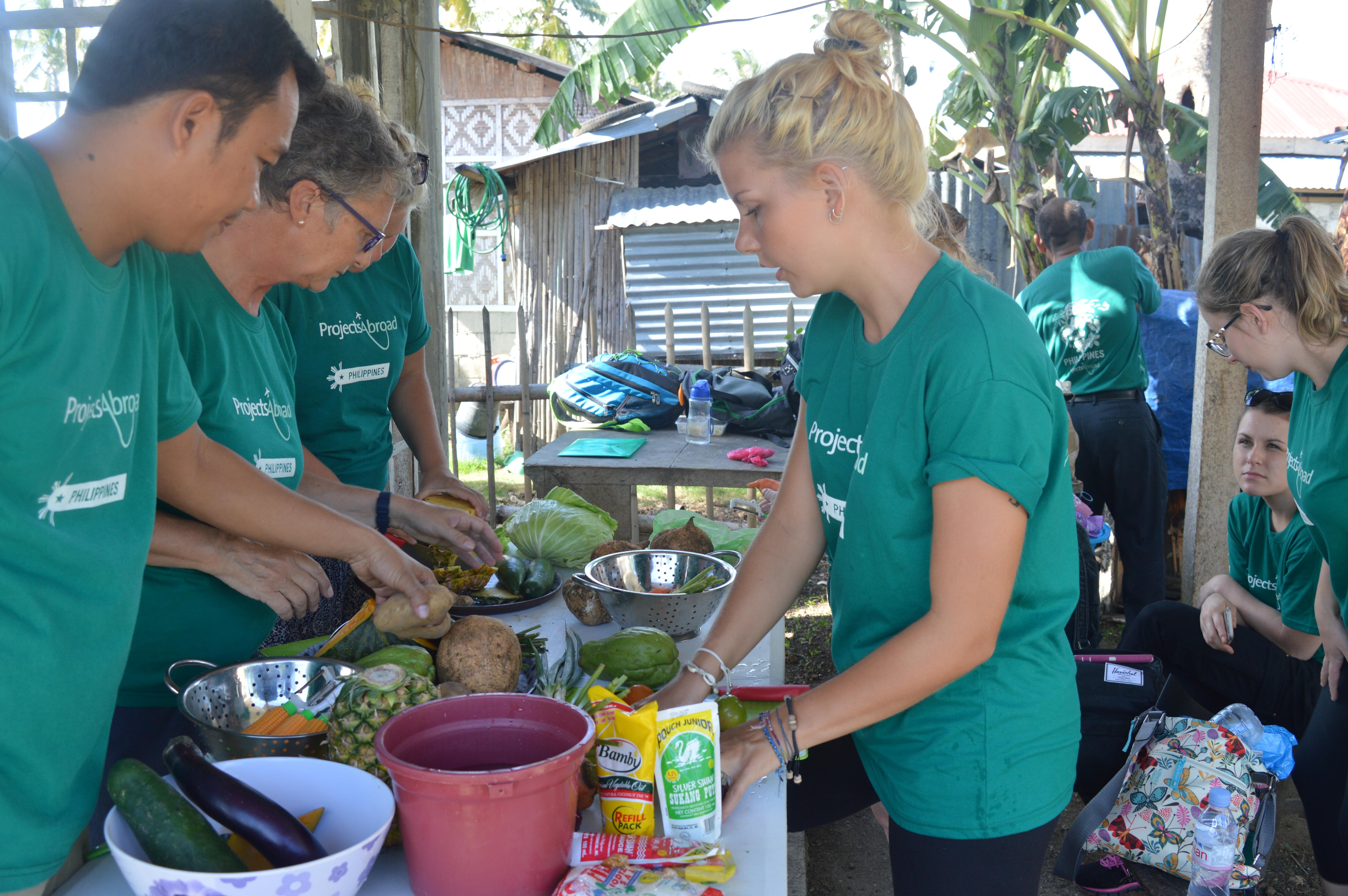 At a Public Health placement for teenagers in the Philippines, students prepare healthy meals as part of healthy living educational campaigns. On the Projects Abroad Public Health Internship for teenagers in the Philippines, students prepare healthy foods for locals.